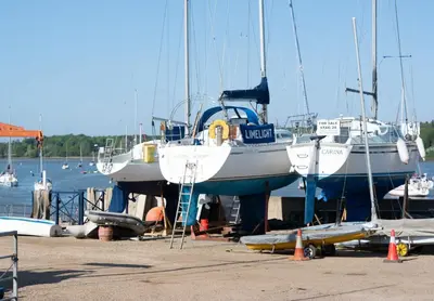 a boat that is sitting on a dock at The Shepherds Hut at Anvil House in Woodbridge