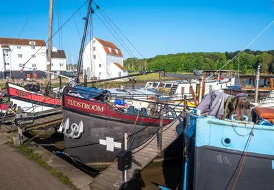 a group of boats docked in a harbor at The Shepherds Hut at Anvil House in Woodbridge
