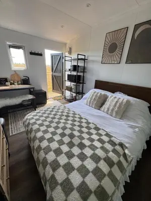 a bedroom with a bed with a checkered blanket at The Old Stable 1 in Messing