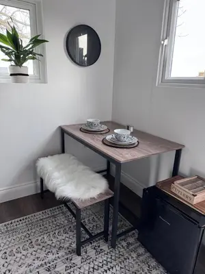 a dining room table with a stool and a mirror at The Old Stable 1 in Messing