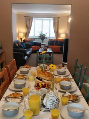 a table topped with plates of food and orange juice at Brandeston Close in Great Waldingfield