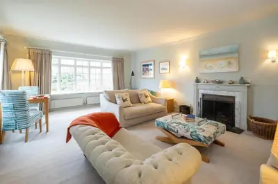 a living room with a couch and a fireplace at 3 The Coastguards, Thorpeness - Only a stones throw from the Beach and very close to famous boating Meare, Country Club and Golf Club - Aldeburgh Coastal Cottages in Thorpeness