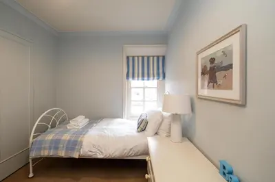 a small bedroom with a bed and a window at 3 The Coastguards, Thorpeness - Only a stones throw from the Beach and very close to famous boating Meare, Country Club and Golf Club - Aldeburgh Coastal Cottages in Thorpeness