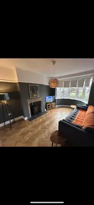 a living room with a couch and a fireplace at Leigh On Sea -Broadway-Two Bed with Garden in Southend-on-Sea
