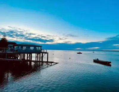 a dock in the water with a house on it at Leigh On Sea -Broadway-Two Bed with Garden in Southend-on-Sea