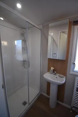 a bathroom with a glass shower and a sink at 25 Poplars Way Walton on Naze in Walton-on-the-Naze