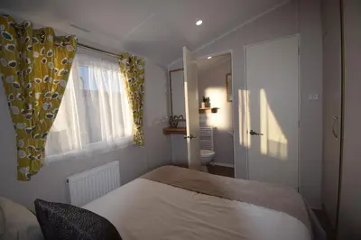a bedroom with a bed and a window at 25 Poplars Way Walton on Naze in Walton-on-the-Naze