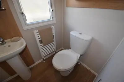 a small bathroom with a toilet and a sink at 25 Poplars Way Walton on Naze in Walton-on-the-Naze