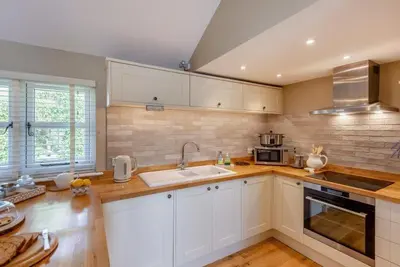 a kitchen with white cabinets and a sink at The Gate Lodge - Pet Free - Near Finchingfield & Saffron Walden in Great Sampford