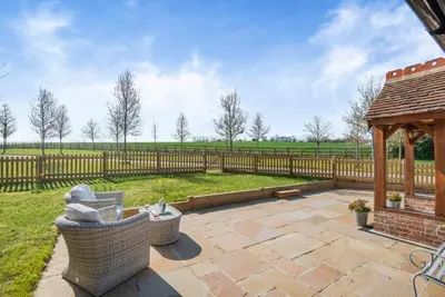 a patio with two chairs and a gazebo at The Gate Lodge - Pet Free - Near Finchingfield & Saffron Walden in Great Sampford