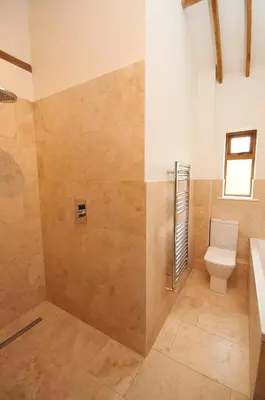 a bathroom with a toilet and a sink at character filled barn renovation in Old Hurst