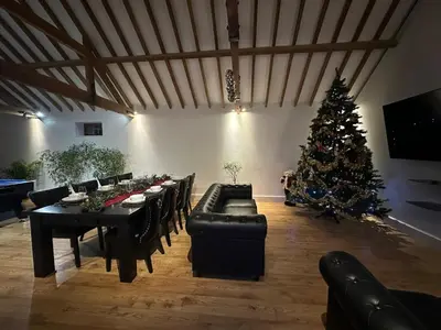 a living room with a christmas tree and a table at character filled barn renovation in Old Hurst