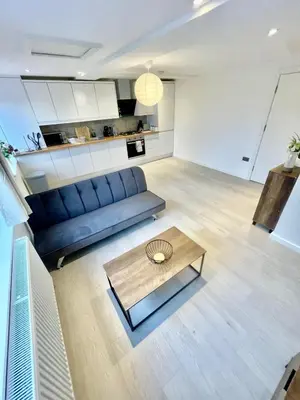 a living room with a blue couch and a coffee table at 2 Bed Flat - Sleeps 5 - Parking - Wifi in Cambridge