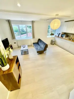 a living room with a couch and a table at 2 Bed Flat - Sleeps 5 - Parking - Wifi in Cambridge