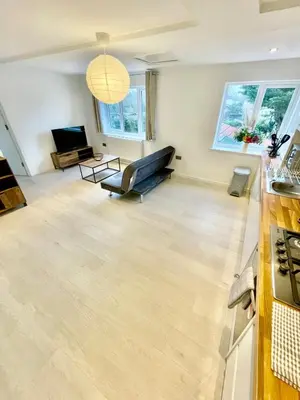a living room with a couch and a television at 2 Bed Flat - Sleeps 5 - Parking - Wifi in Cambridge