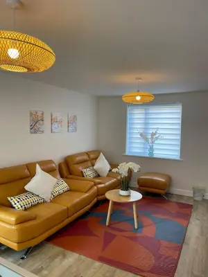 a living room with a couch and a table at Brand new prestigious house near science park in Cambridge