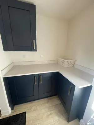 a kitchen with blue cabinets and a counter top at Brand new prestigious house near science park in Cambridge