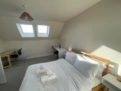 a bedroom with a bed with two towels on it at Brand new prestigious house near science park in Cambridge