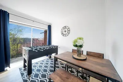 a living room with a table and a stove at Chic Colchester Flat in Colchester