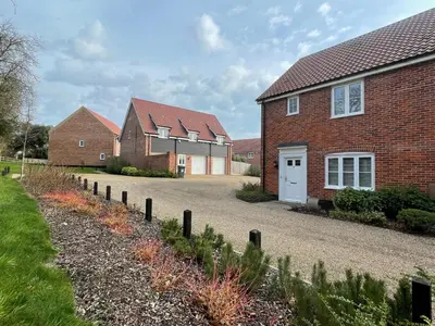 a row of brick houses with a driveway at Suffolk 3-BR Coastal House Aldeburgh & Thorpeness in Aldringham