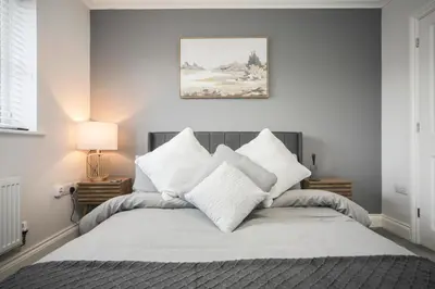 a bedroom with a bed with white sheets and pillows at Suffolk 3-BR Coastal House Aldeburgh & Thorpeness in Aldringham