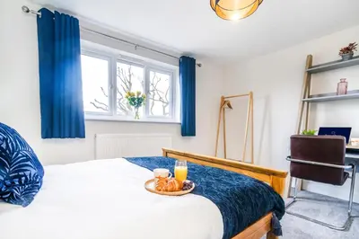 a bedroom with a bed with a bowl of fruit on it at 2 Bed Elegant home with Parking in Harlow in Harlow