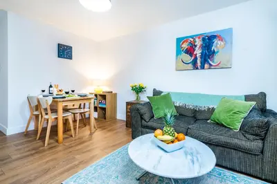 a living room with a couch and a table at 2 Bed Elegant home with Parking in Harlow in Harlow