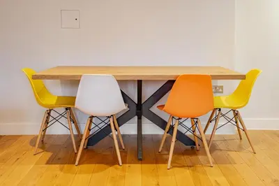 a wooden table with four chairs around it at Lovely Central Brentwood Flat in Brentwood
