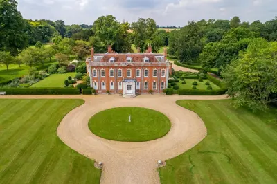 an aerial view of a large house with a large yard at Belchamp Hall Stables in Belchamp Otten