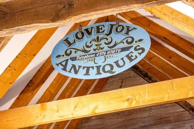 a sign hanging from the ceiling of a building at Belchamp Hall Hayloft in Belchamp Otten