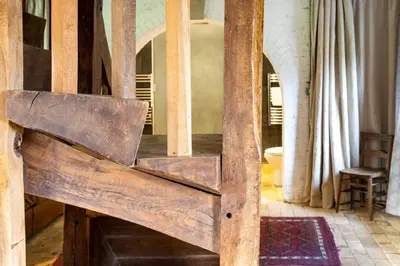 a wooden bench in the middle of a room at Belchamp Hall Mill in Belchamp Otten