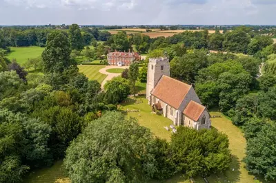 an aerial view of an old house with trees at Belchamp Hall Mill in Belchamp Otten