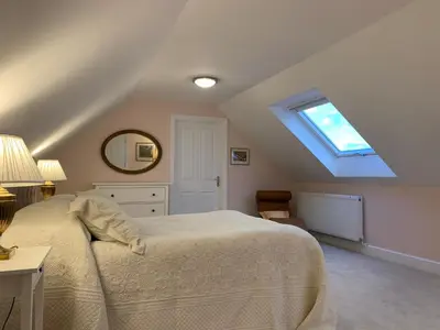 a bedroom with a bed and a skylight at Magog View in Sawston