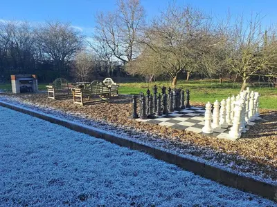 a chess board in the middle of a park at Low Farm Barn, a family and dog friendly haven in Brundish