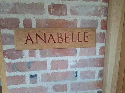 a sign on a brick wall with the word antifiable at Low Farm Barn, a family and dog friendly haven in Brundish