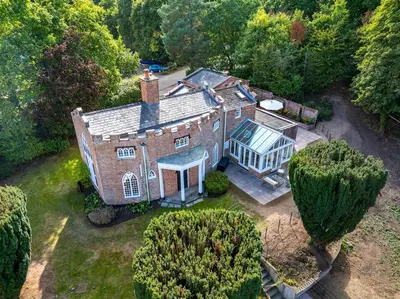 an aerial view of an old house with trees at The Cat House in Woolverstone