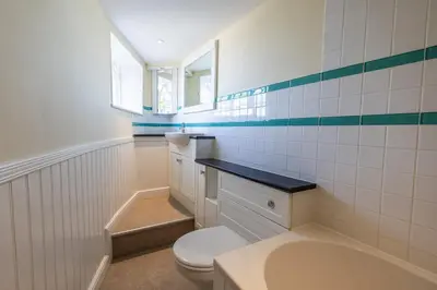 a bathroom with a toilet and a sink at The Cat House in Woolverstone