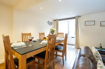 a dining room with a table and chairs at Emeny Cottage - Aldeburgh Coastal Cottages in Aldeburgh