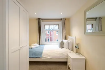 a bedroom with a bed and a window at Emeny Cottage - Aldeburgh Coastal Cottages in Aldeburgh