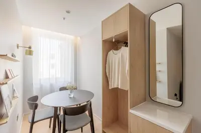 a small room with a table and a mirror at Wilde Cambridge City Centre in Cambridge