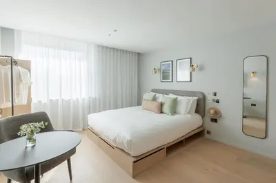 a bedroom with a bed and a table and a chair at Wilde Cambridge City Centre in Cambridge