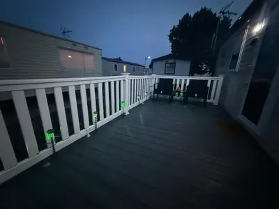 a deck at night with lights on it at 6 Beds 2 Sofa bed Family friendly - unlimited Wi-Fi, Warm, Cozy Sun decking Caravan at Seawick Holiday Park in Saint Osyth