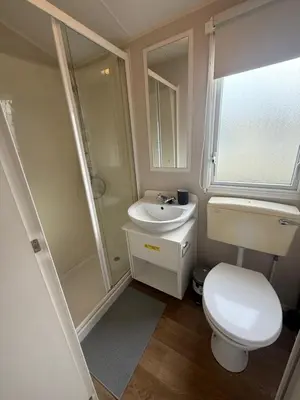 a small bathroom with a toilet and a sink at 6 Beds 2 Sofa bed Family friendly - unlimited Wi-Fi, Warm, Cozy Sun decking Caravan at Seawick Holiday Park in Saint Osyth