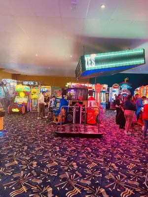 a group of people playing video games in a casino at 6 Beds 2 Sofa bed Family friendly - unlimited Wi-Fi, Warm, Cozy Sun decking Caravan at Seawick Holiday Park in Saint Osyth