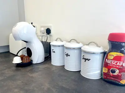 a group of coffee cups and a mixer on a counter at New Modern 2 Bed with parking in BISHOPS STORTFORD, close to Stansted Airport! in Bishops Stortford