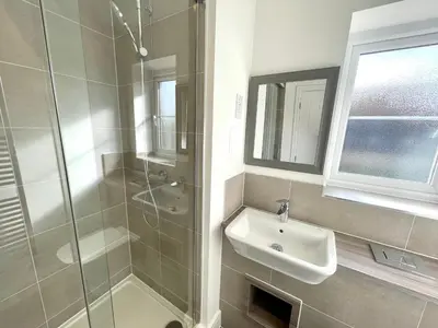 a white bathroom with a sink and a shower at New Modern 2 Bed with parking in BISHOPS STORTFORD, close to Stansted Airport! in Bishops Stortford