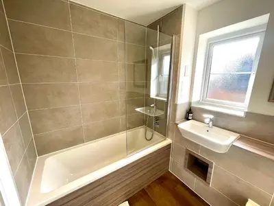 a bathroom with a shower and a sink at New Modern 2 Bed with parking in BISHOPS STORTFORD, close to Stansted Airport! in Bishops Stortford