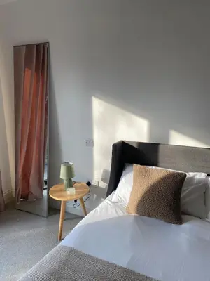 a bedroom with a bed and a table with a lamp at Number Forty One in Sudbury