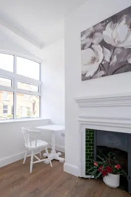a white room with a table and a fireplace at 2 Volunteer House, Leiston - Aldeburgh Coastal Cottages in Leiston