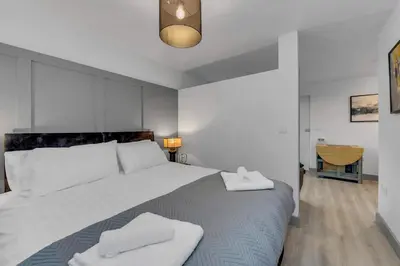 a bedroom with a large bed with two towels on it at Cosy 1-Bed Apt in Newmarket with Parking in Newmarket